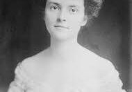 Black and white portrait of a young woman in vintage attire.