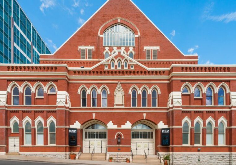 Historic red-brick building with arched windows and intricate architectural details.