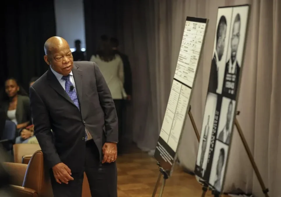 Man in suit presenting information on display boards.