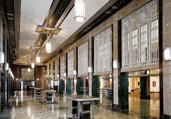 Spacious, vintage-style interior with mosaic floors and large windows.