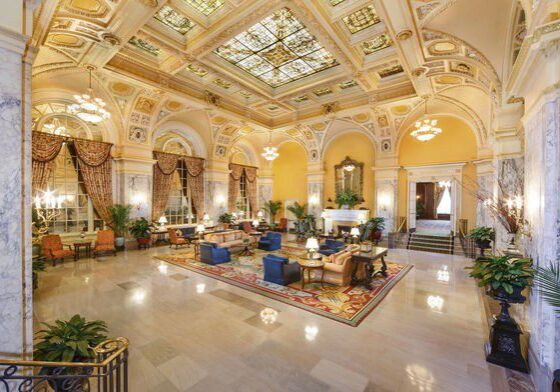 Luxurious hotel lobby with elegant decor and grand chandeliers.