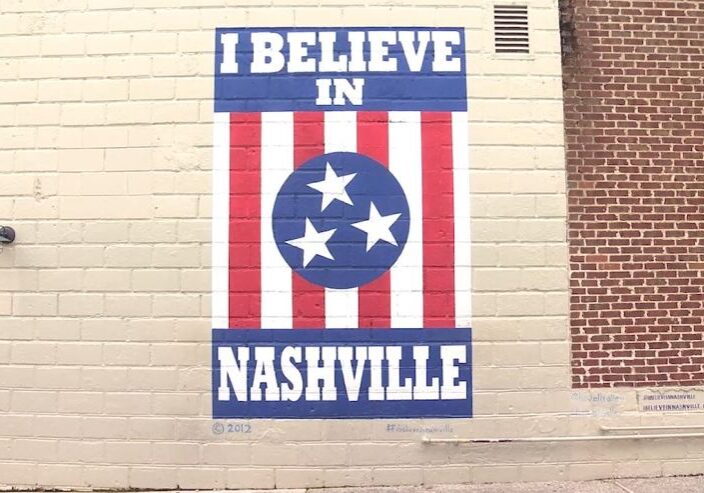 A patriotic mural stating 'I believe in Nashville' with a Tennessee flag motif.