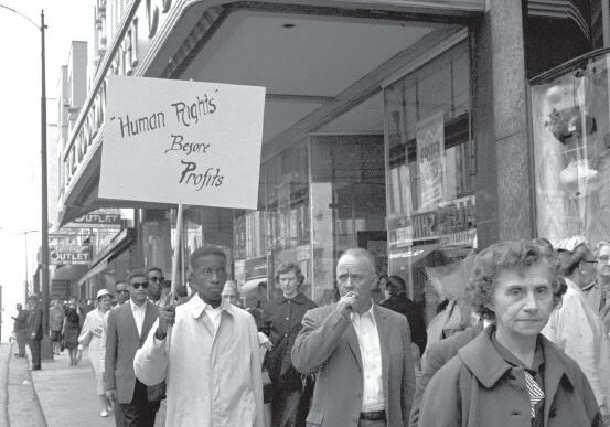 A group of people protesting with a sign about peace.